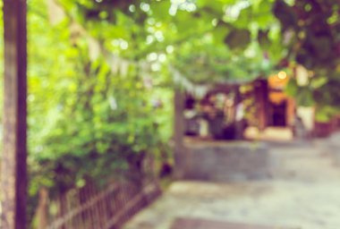 Arkaplan kullanımı için bokeh ile yeşil bahçe için açık alan ile uzun boş koridorun bulanık görüntüsü.