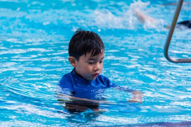 Yüzme havuzundaki Asyalı çocuk. .
