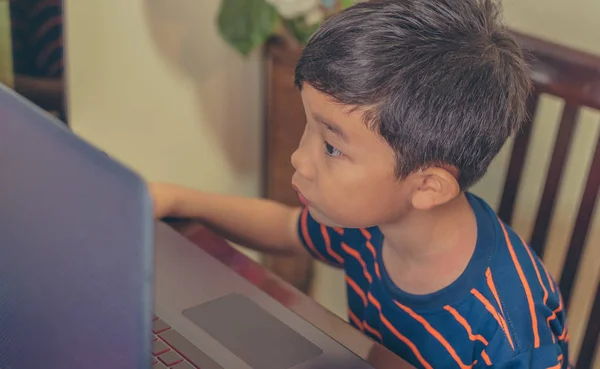 Boy using computer laptop on table. — Stock Photo, Image