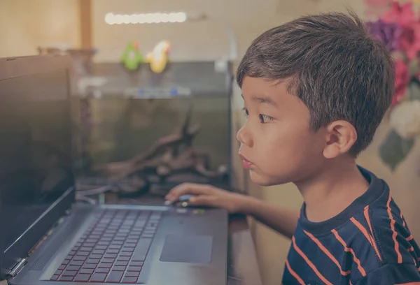 Boy using computer laptop on table. — Stock Photo, Image
