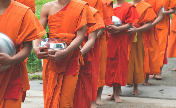  unrecognizable monk walking on street.