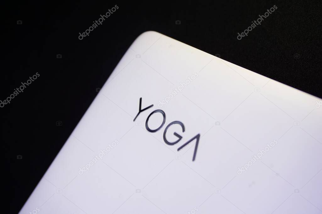 Close up of Lenovo yoga logo on the laptop surface.