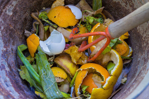 old bucket with vegetables and other rubbish to make compost - closeup