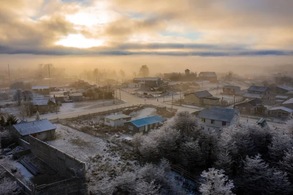Aerial view of sunrise over the city with snow and fog