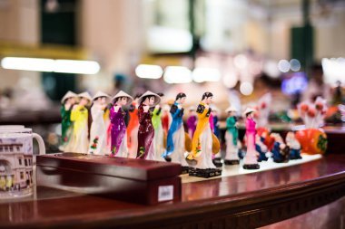 Ho chi minh city, Vietnam, April 22 2016.Dolls wearing Ao dai, which are on sale for tourists at Saigon Central Post Office. clipart