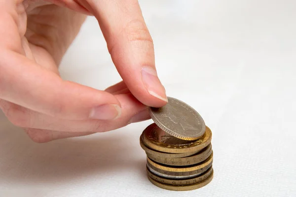 Saving Money Hand Puts Coins Different Countries Pile White Background — Stock Photo, Image