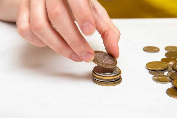 Saving Money Hand Puts Coins Different Countries Pile White Background — Stock Photo, Image