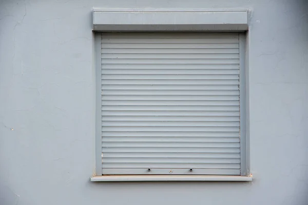 窗户上紧闭的灰色百叶窗 在交易中出现问题的概念 或者没有人在屋里 — 图库照片