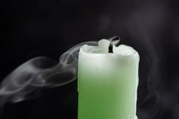 Smoke from a candle on a black isolated background. An interesting and weird smoke pattern, close-up, abstraction.