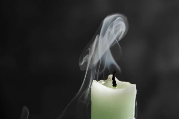 Smoke from a candle on a black isolated background. An interesting and weird smoke pattern, close-up, abstraction.