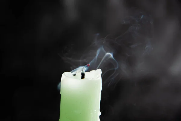 Smoke from an extinguished candle isolated on a black background. Can be used as background. Symbol of sorrow.