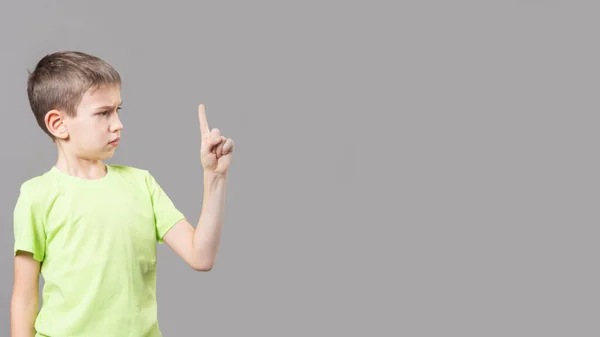 Pequena Criança Caucasiana Uma Camiseta Verde Aponta Dedo Para Cima — Fotografia de Stock