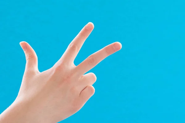 Close Female Hand Showing Pointing Number Three Fingers Blue Background — Stock Photo, Image
