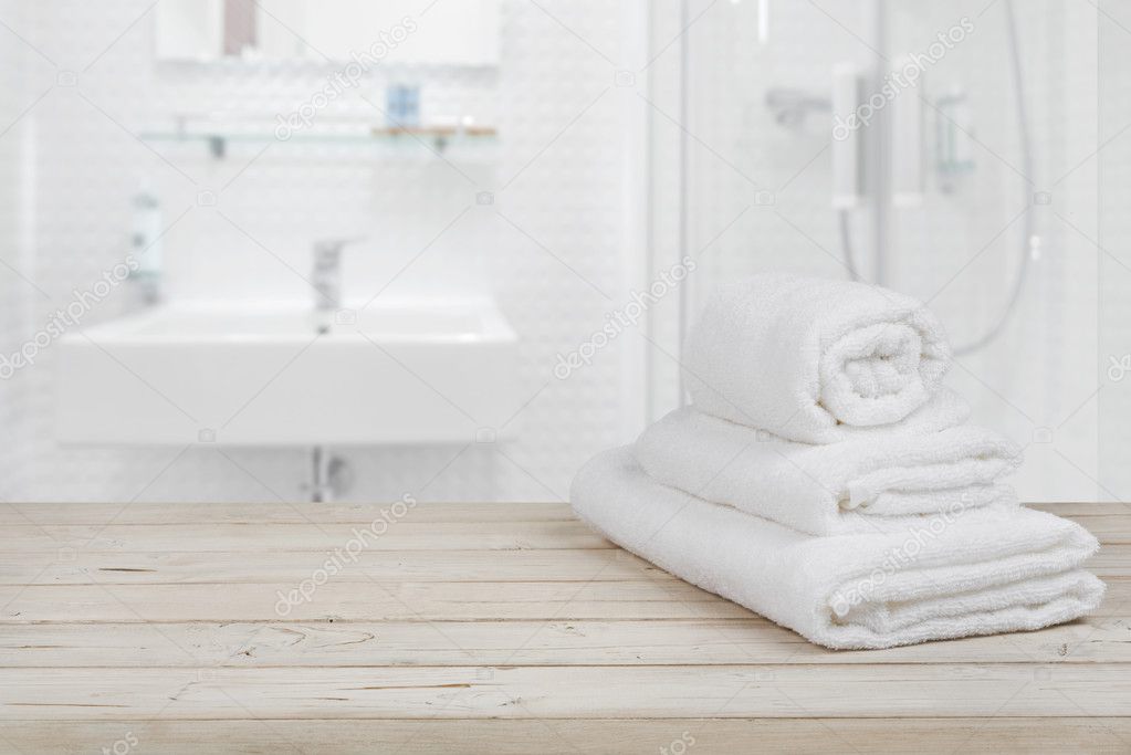 Download Blurred Bathroom Interior Background And White Spa Towels On Wood Stock Photo Image By C Didecs 128319664
