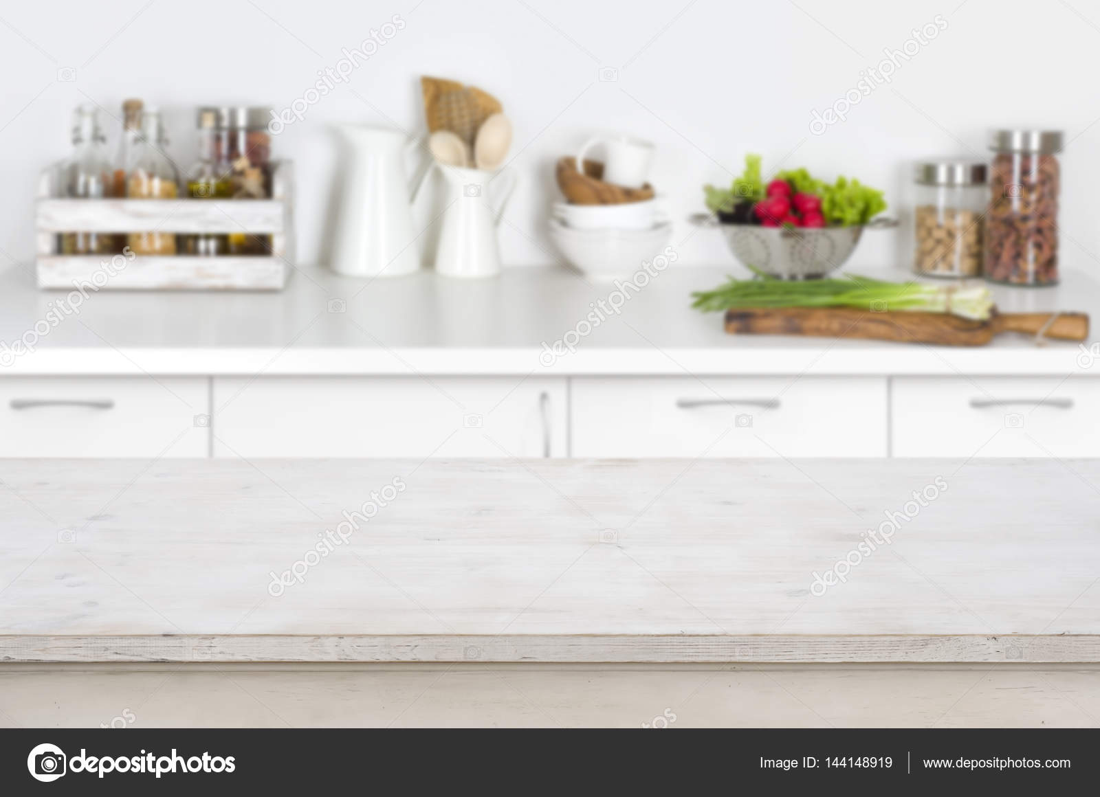 Wooden table on blurred kitchen interior background with fresh