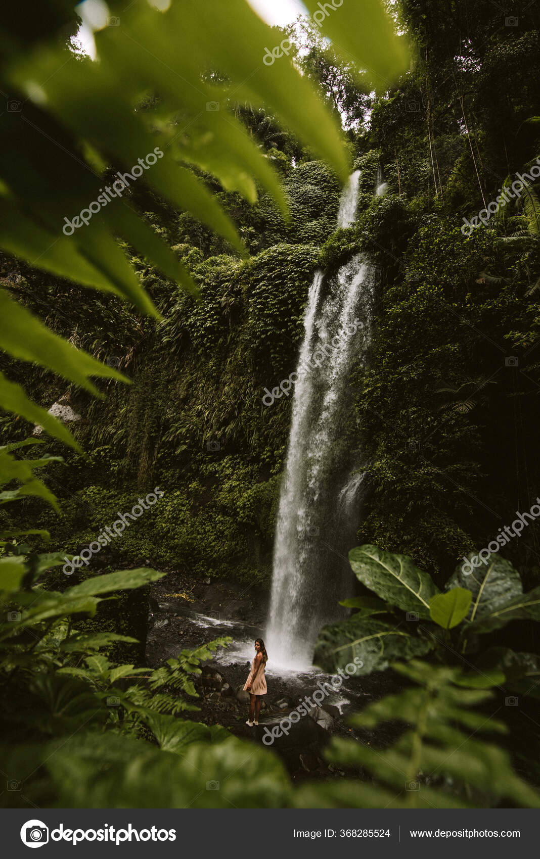 Elegant pose against waterfall with rainbow - photo by Frøydis