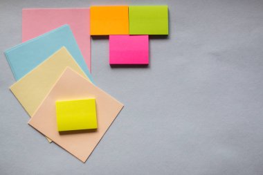 Açık arkaplandaki renkli yapışkan notlar. Yukarıdan manzara. Mesaj için yer var. Yatay resimler