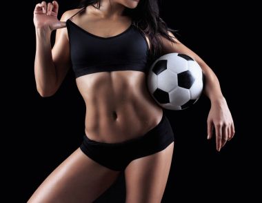 Güzel vücut fitness modeli futbol topu tutan 