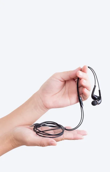 Una mano de mujer sosteniendo auriculares — Foto de Stock