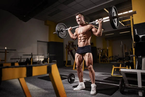 Muscular bodybuilder guy doing exercises with dumbbell — Stock Photo, Image