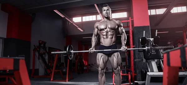 Muscular fisiculturista cara fazendo exercícios com halteres — Fotografia de Stock