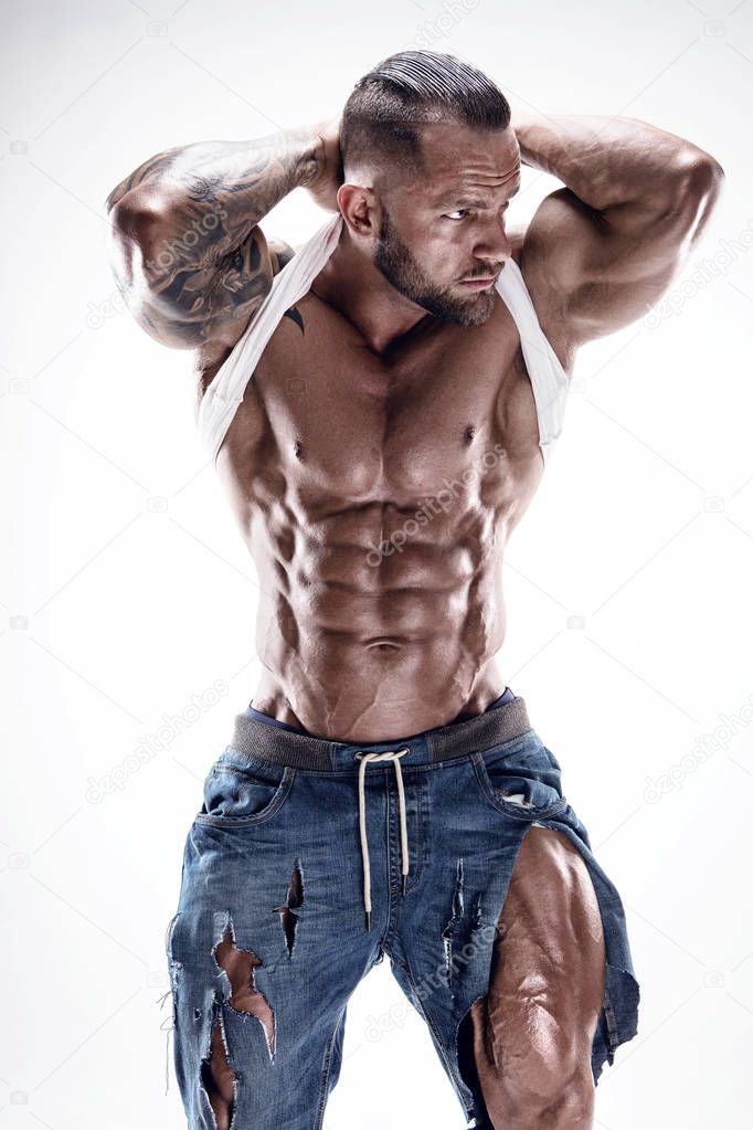 portrait of strong Athletic Fitness man showing big muscles over white background