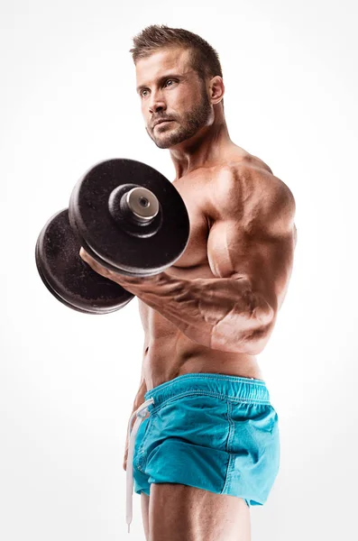 Muscular bodybuilder guy doing exercises — Stock Photo, Image