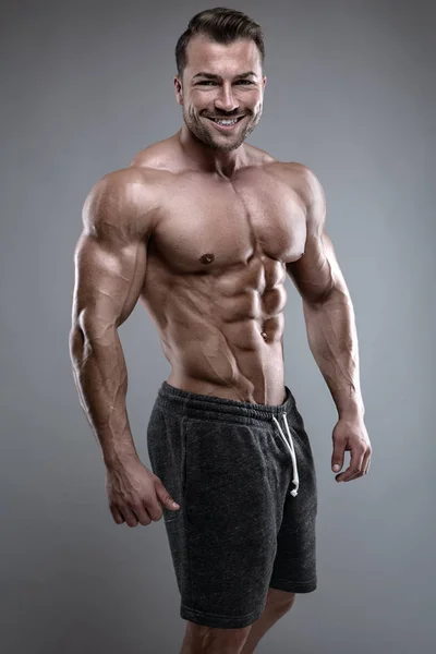 Strong Athletic Man shows body and abdominal muscles — Stock Photo, Image