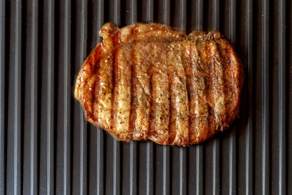 Pork steak grilled on an electric grill