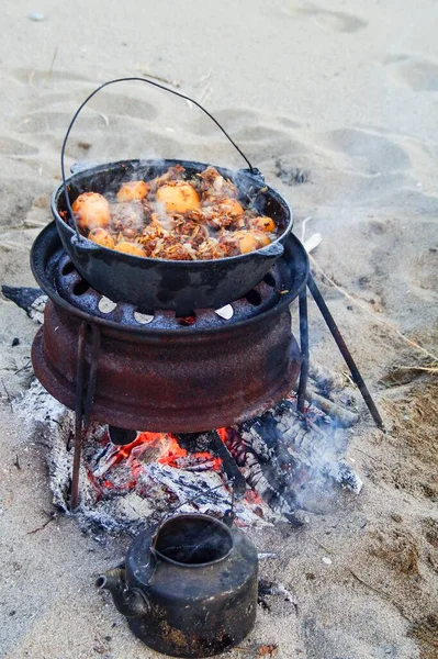 tasty food cooked with smoke on a campfire in nature