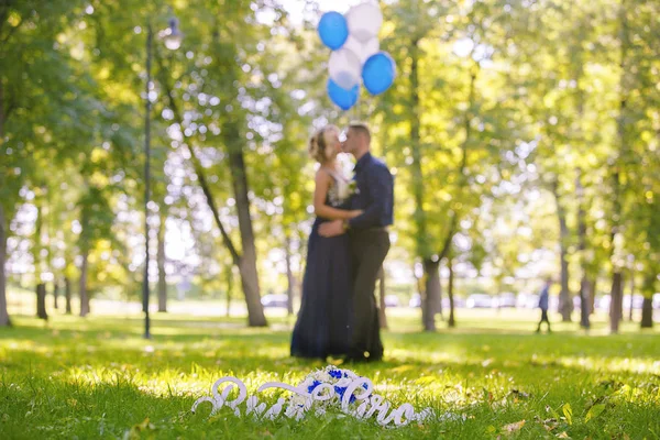 Sign of grooom and bride on the grass — Stock Photo, Image