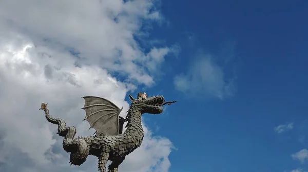 Statue of a flying dragon against the sky