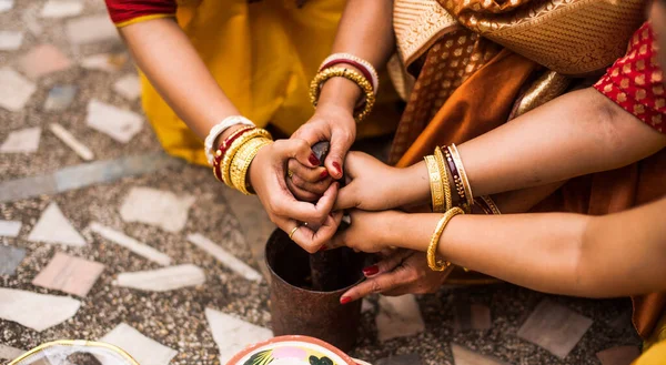 Group of women is performing Indian Bengali wedding rituals
