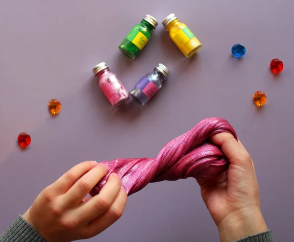 Childs Hands Play Pink Slime Blue Background Next Multicolored Paints — Stock Photo, Image