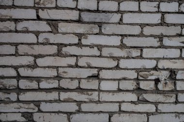 Eski, kirli, beyaz tuğladan bir duvarın arka planı. Alçı, boyalı duvarlar, doku.
