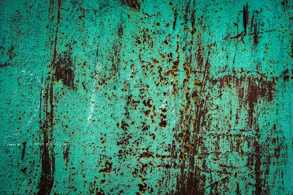 Texture of a rusty metal surface with white, green, salt, evergreen, dark blue, blue, aged cracked paint. Rusty and scratched painted metal wall