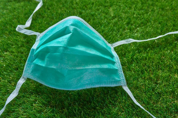 Disposable mask. Disposable mask on grass.