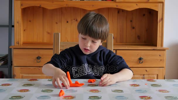 Child Modeling Orange Clay — Stock Video
