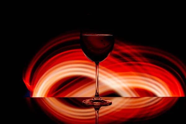 Glas für Wein vor dem Hintergrund heller Farblösungen — Stockfoto