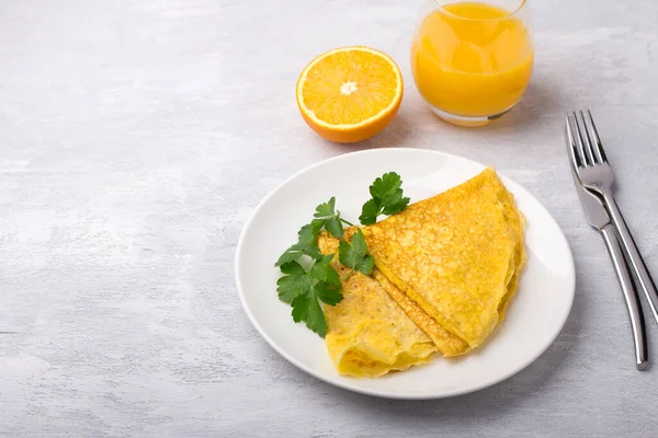 Keto breakfast high-fat low-carb, pancakes without flour and nuts, freshly squeezed orange juice on a light gray background, free space