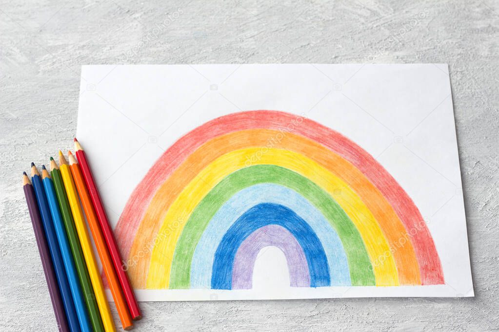 Children's drawing with a rainbow and colored pencils on a light gray background. Rainbow flash mob on social networks during quarantine as a symbol of hope