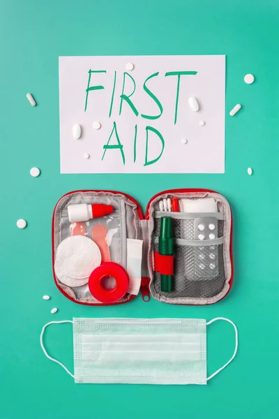 Creative layout of medicines for first aid, first aid kit for tourists, bandages, painkillers, plaster.cotton wool, cotton sticks, tampons on a turquoise background