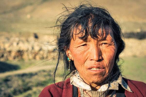 Woman with blue earrings in Nepal