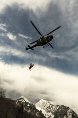 Rescue mission in the Alps. clipart