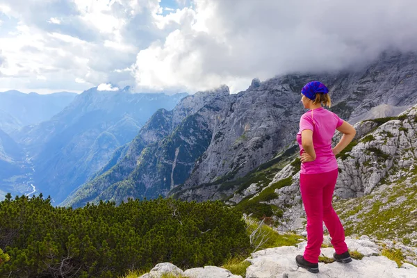 Active woman exercising in the nature above the beautiful valley