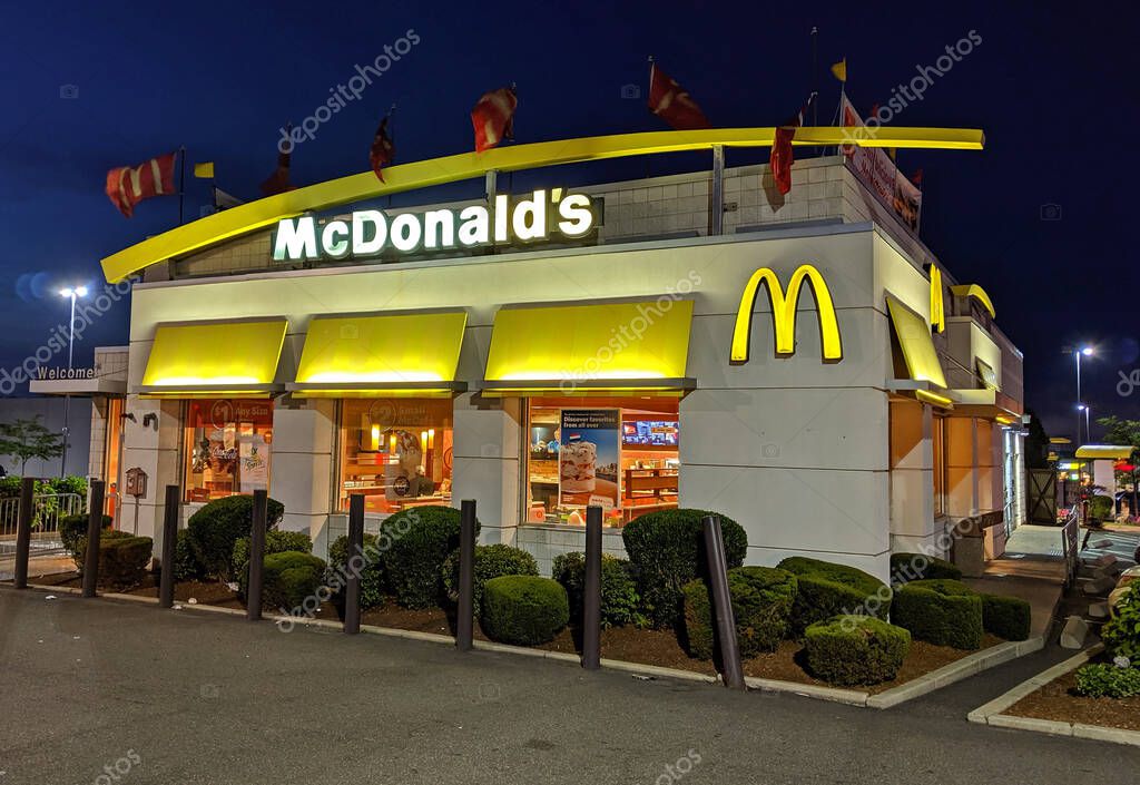 McDonald's fast food restaurant storefront windows, evening customers