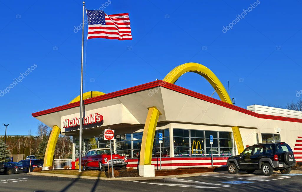 McDonald's drive thru fast food restaurant, American flag waving
