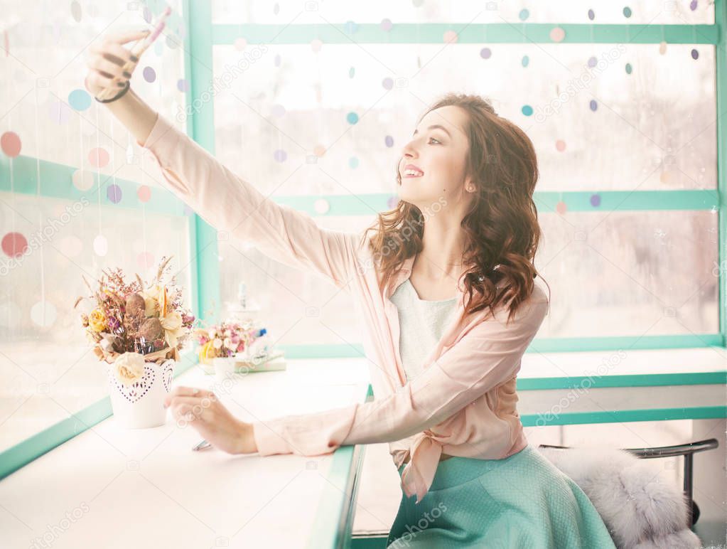 Vintage toned photo of pretty girl in cafe selfie