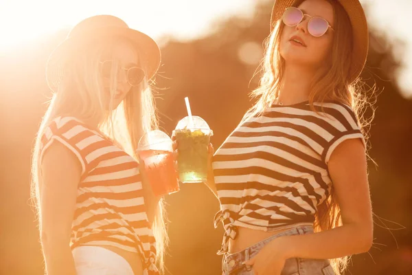 Portrait of two young beautiful girls in trendy stripe shirt, be — Stock Photo, Image
