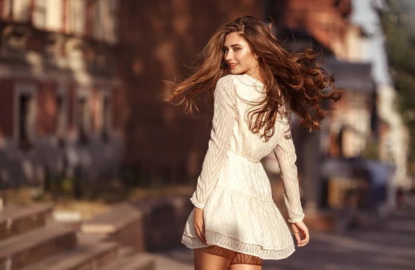 Beautiful young girl with long healthy hair, nice dress walking — Stock Photo, Image